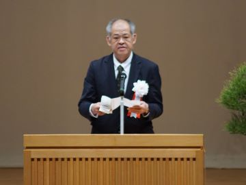 農林水産大臣挨拶を代読する石川農村振興局整備部長