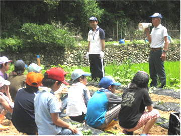 被災地支援に向けて、耕作放棄地でさつまいも栽培エコクラブに指導を受ける児童