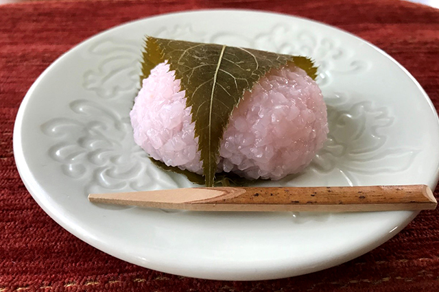 Sakuramochi (pink-colored rice cake filled with red bean paste wrapped with a cherry blossom leaf)