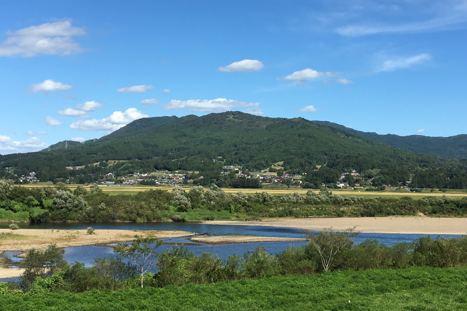 北上川の対岸から望む束稲山麓地域（平泉町長島）