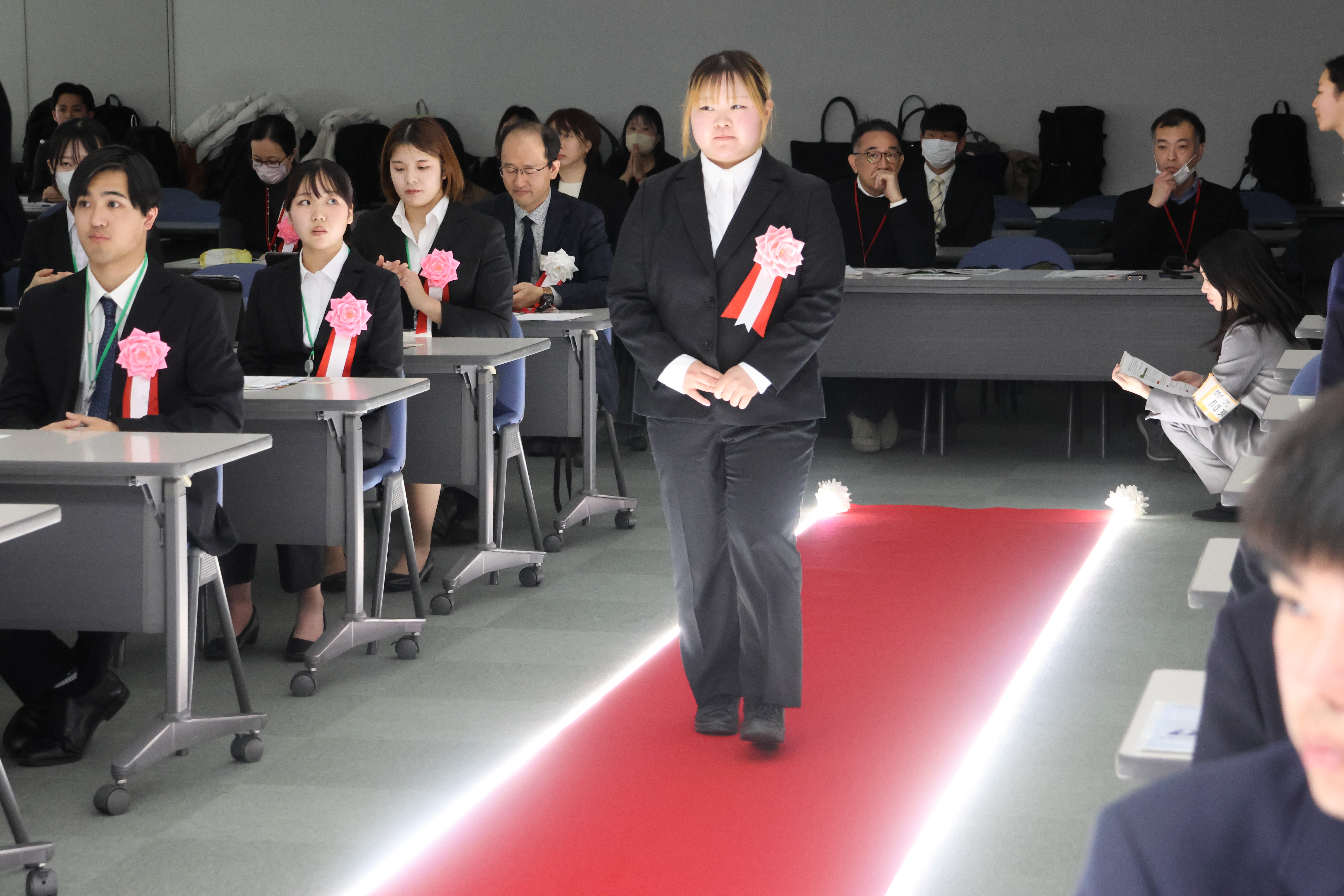 レッドカーペットを歩く学生