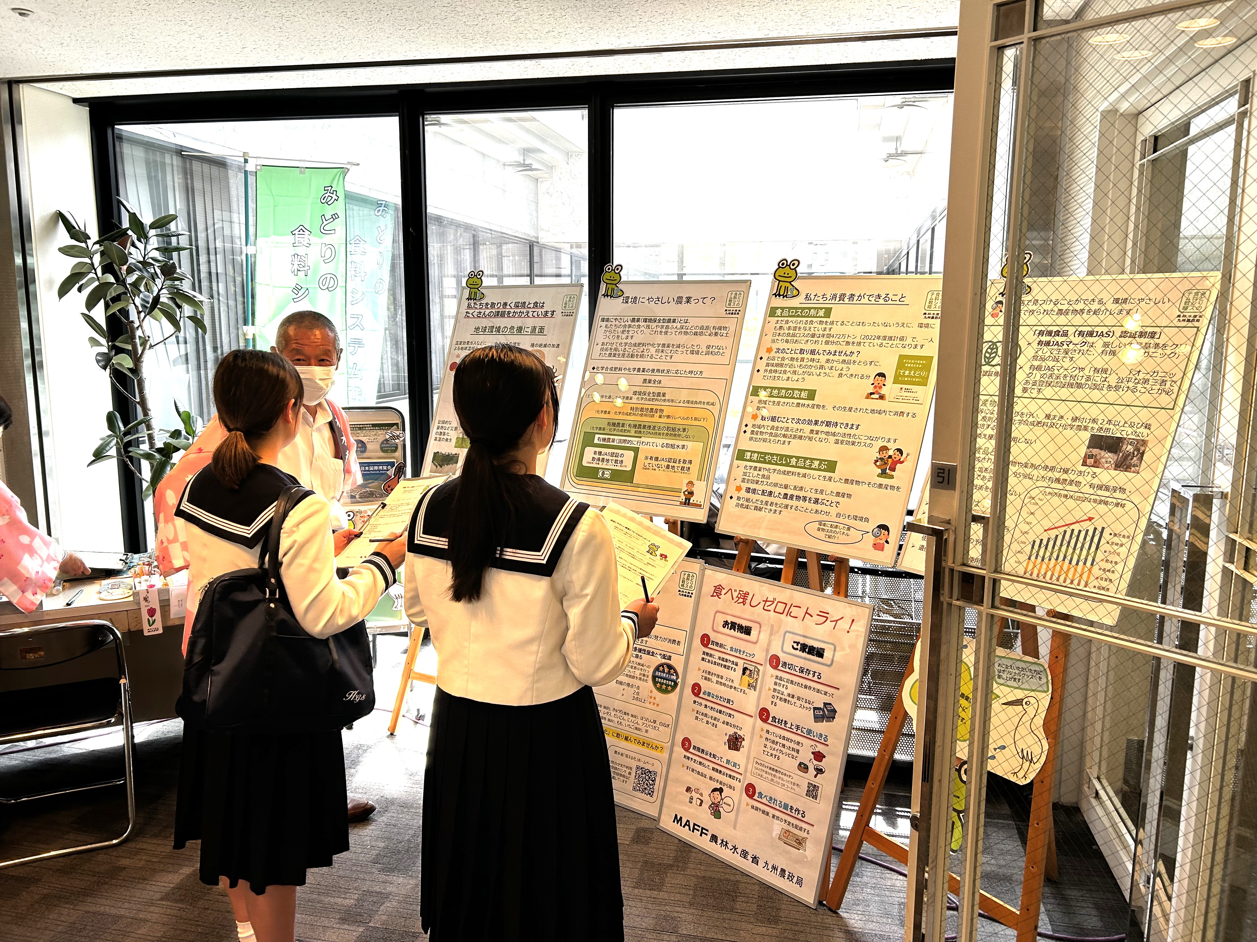 出展ブースに展示されたパネルを見てアンケートに答える高校生